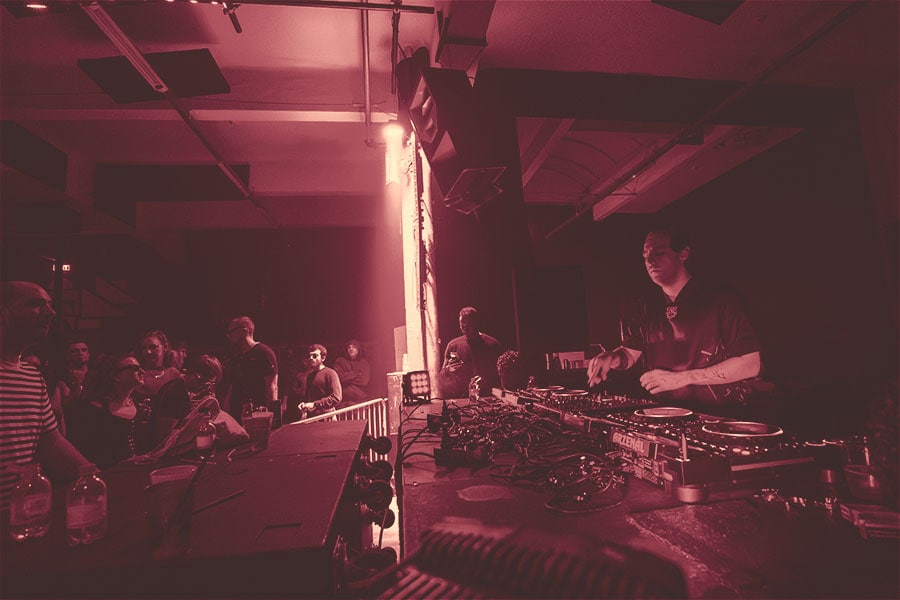 Electronic music crowd in a dark room
